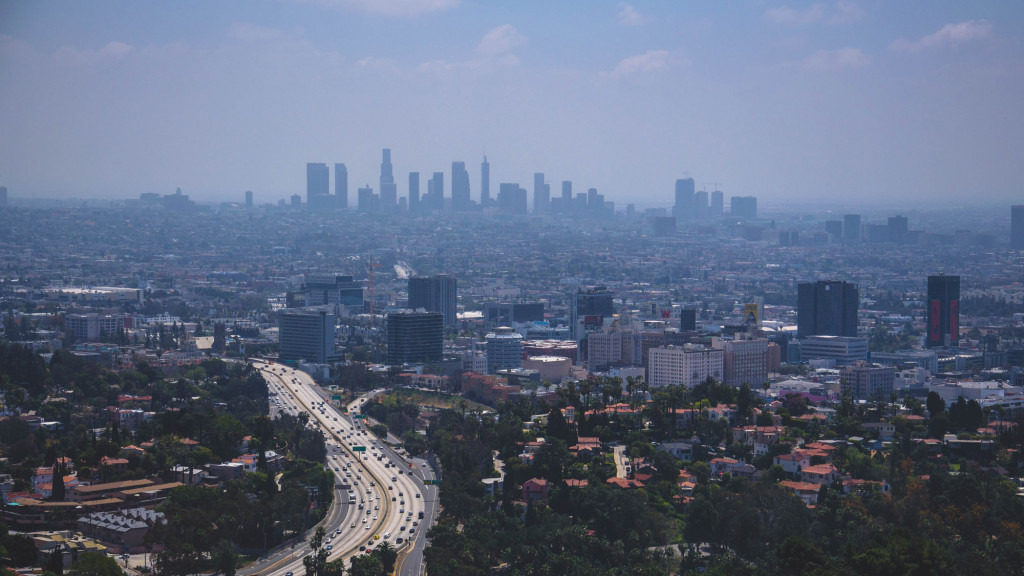 A city with a freeway and buildings.