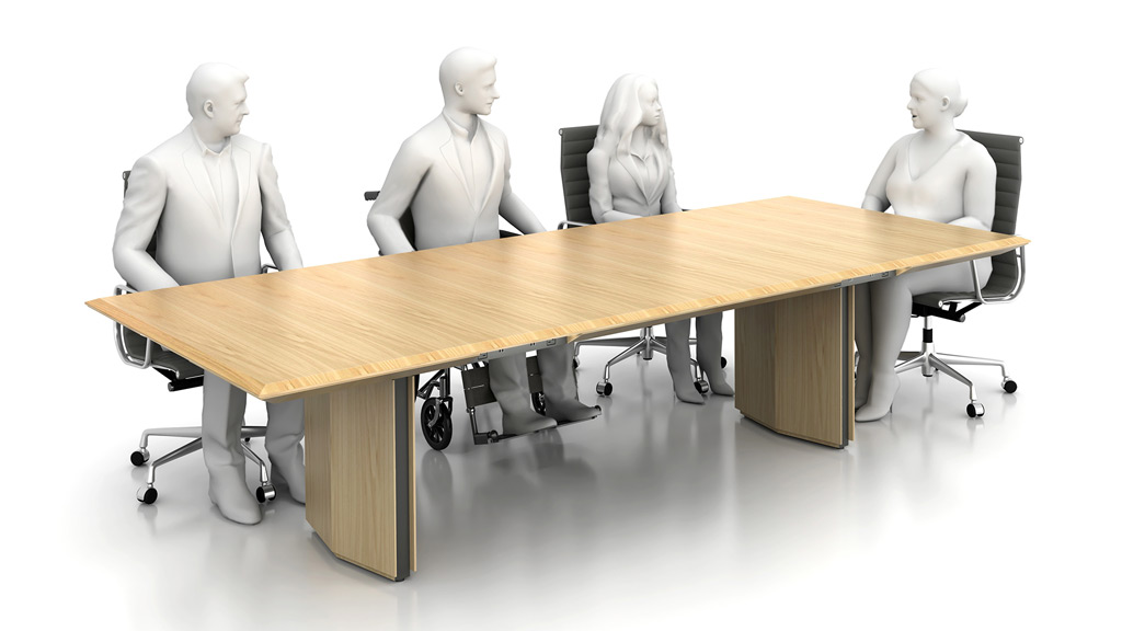 A group of people sitting at a table designed for inclusivity.