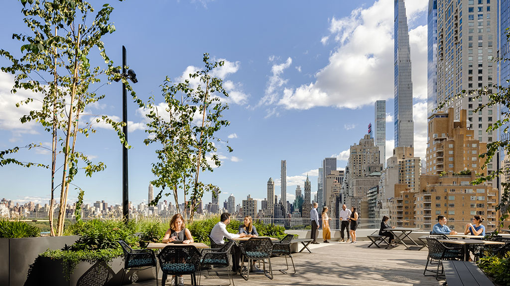 People sitting at tables in a park.